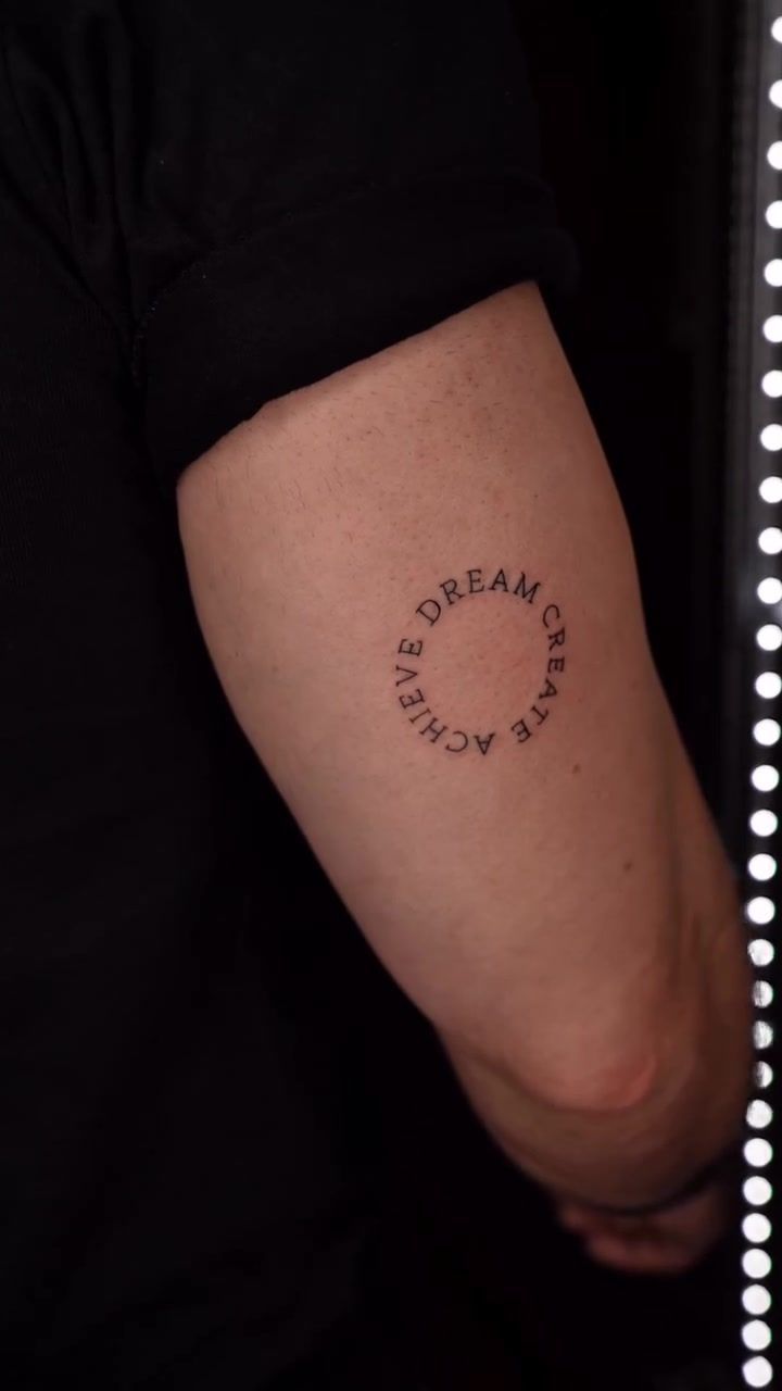 Dream Create Achieve circular lettering tattoo with geometric arrangement