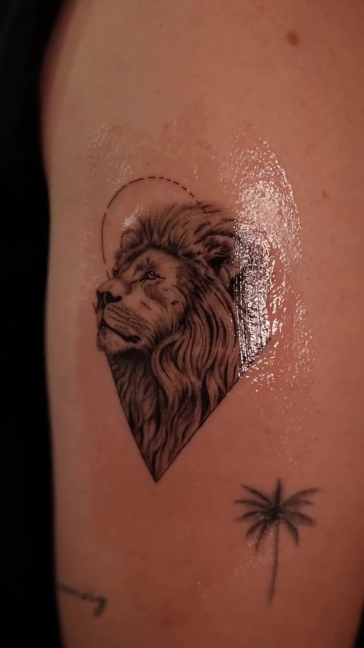 Lion portrait in a diamond frame, micro realism fineline on the upper arm