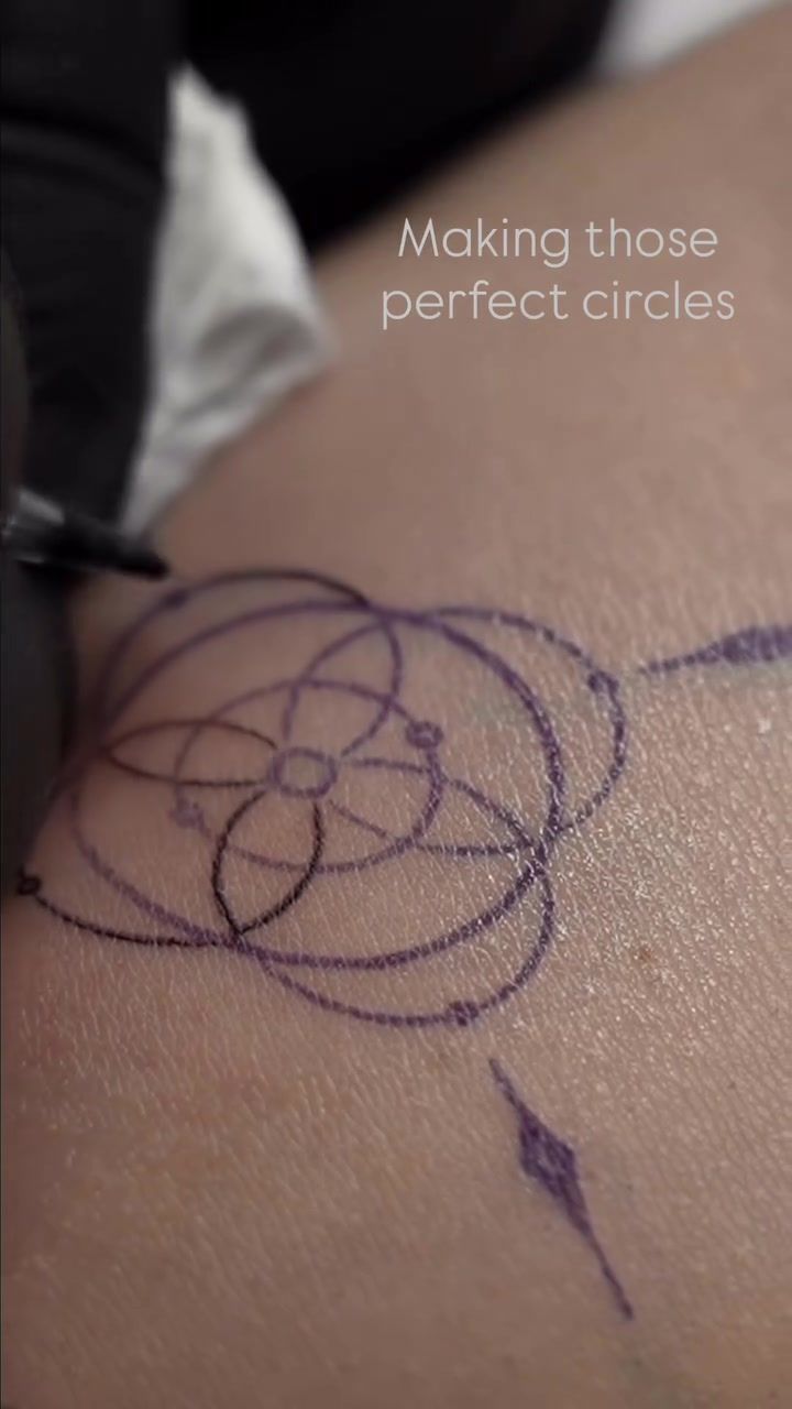 Close-up of a precise geometric circle tattoo showing clean linework